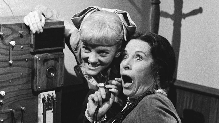 Alison Arngrim scheming as Nellie Oleson with Katherine MacGregor in character looking surprised