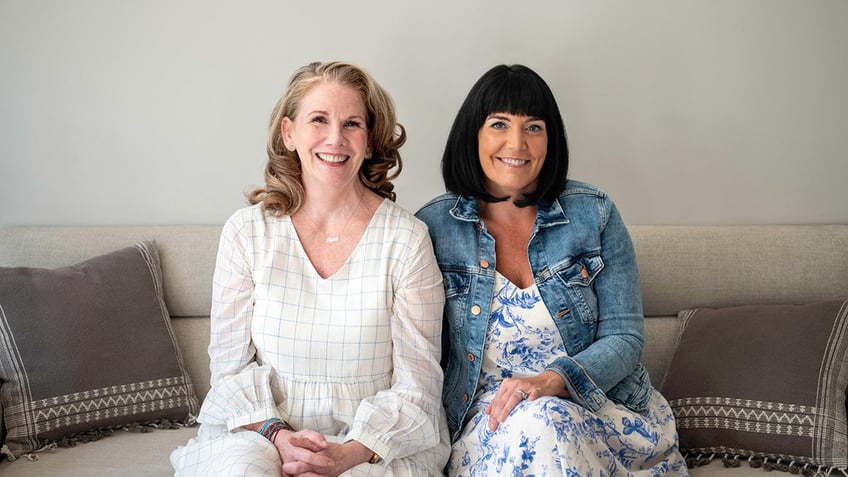 Melissa Gilbert in a white blouse sitting next to a woman wearing a denim jacket.