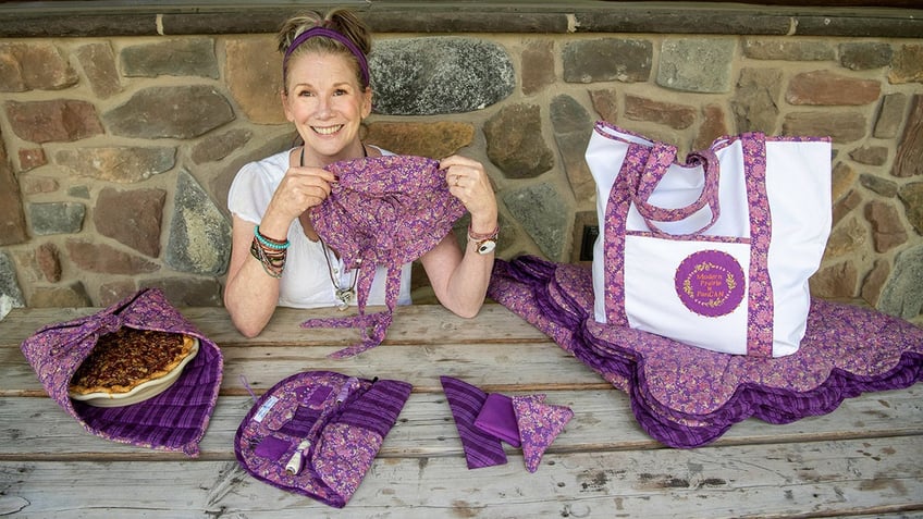 Melissa Gilbert holding her purple lifestyle collection