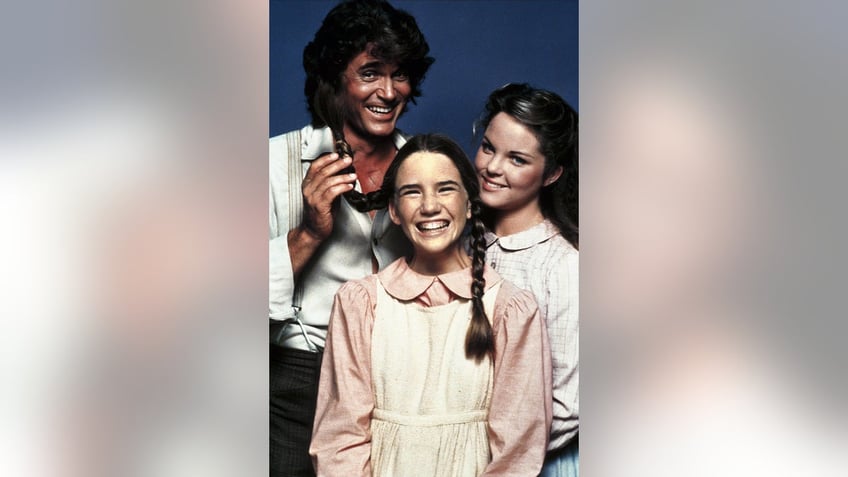 Michael Landon playing with Melissa Gilberts pigtails.