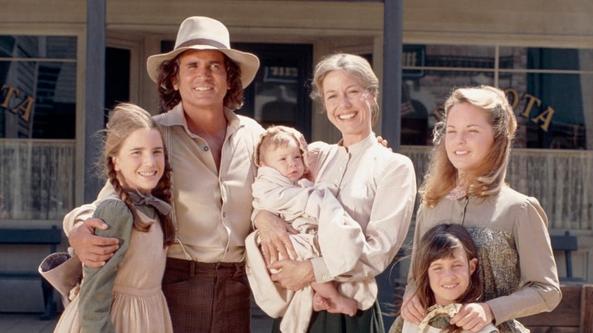 The cast of Little House on the Prairie posing together.