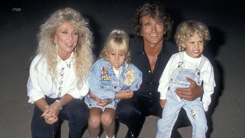 Michael Landon holding on to two of his young children
