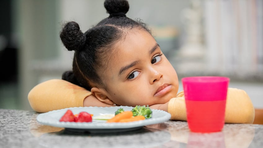 Upset toddler refuses to eat healthy meal because she is a picky eater