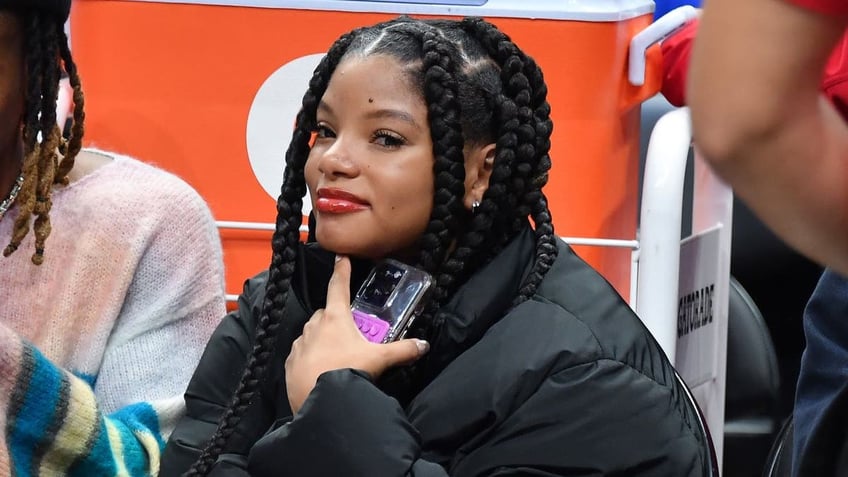 Halle Bailey smiling at basketball game