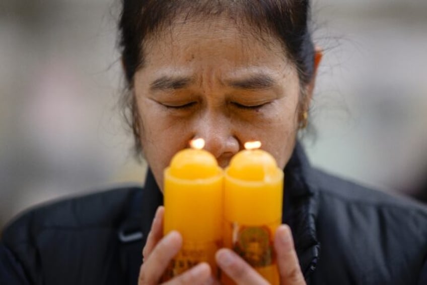 A woman prays at Seoul's Jogyesa Buddhist temple, where prayers are being held for student