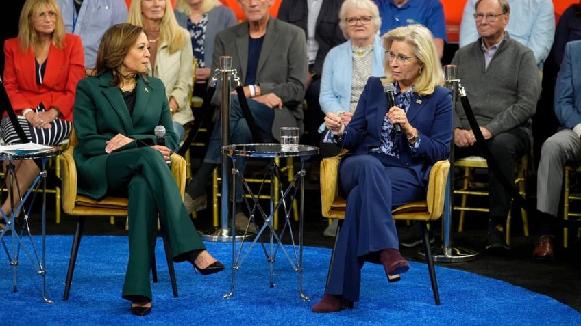 Democratic presidential nominee Vice President Kamala Harris listens as Former Republican Congresswoman Liz Cheney speaks during a town hall at The People's Light in Malvern, Pa., Monday, Oct. 21, 2024. 
