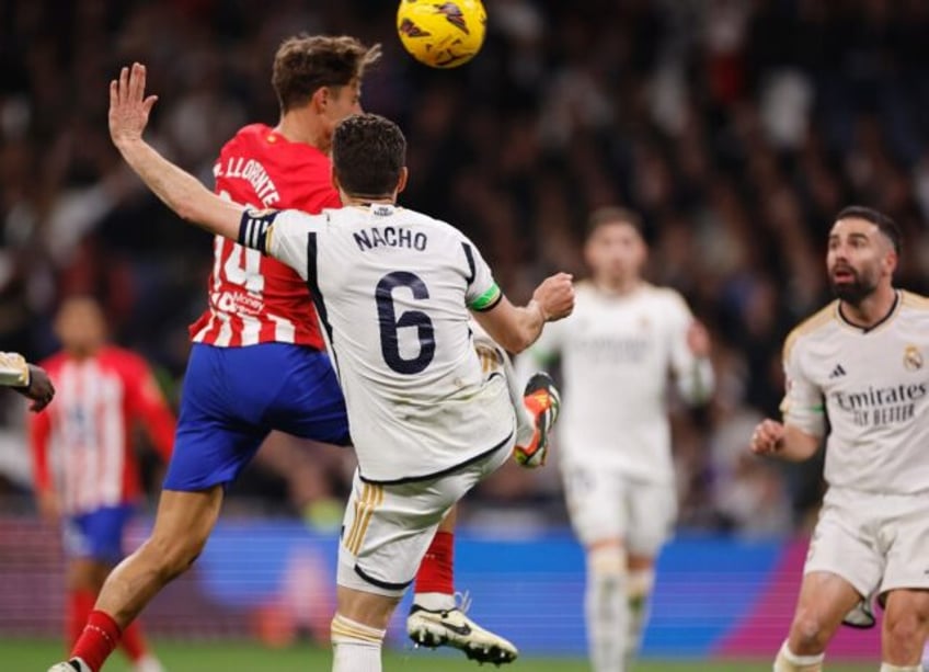 Marcos Llorente heads home the equaliser for Atletico Madrid in the 1-1 draw with rivals and La Liga leaders Real Madrid