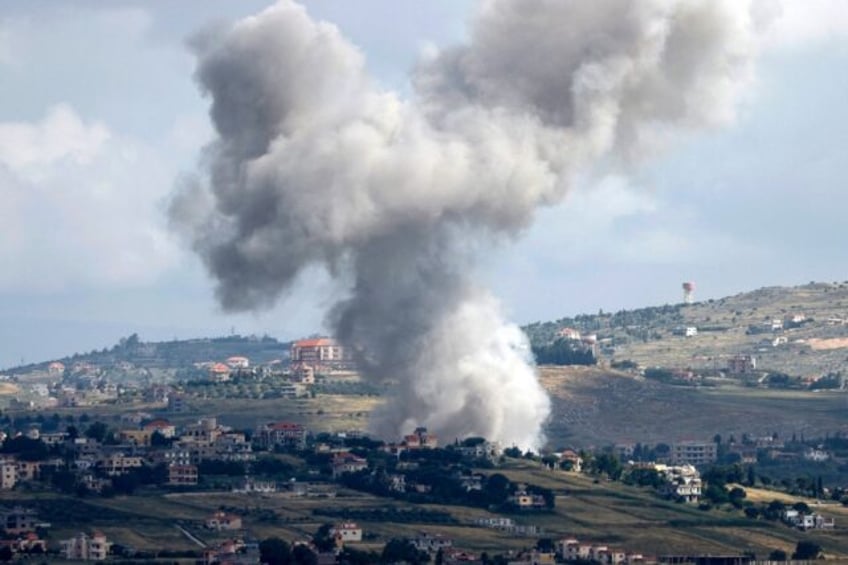 Seen from northern Israel, smoke billows above the Lebanese village of Mays al-Jabal durin