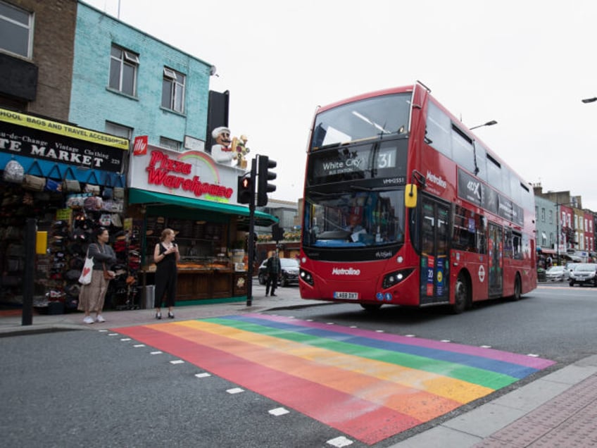 LONDON, ENGLAND - JULY 04: Members of the Public walk over the LGBT road painted sign on Camden High Street in Camden Town on July 04, 2020 in London,United Kingdom . (Photo by Jo Hale/Getty Images)