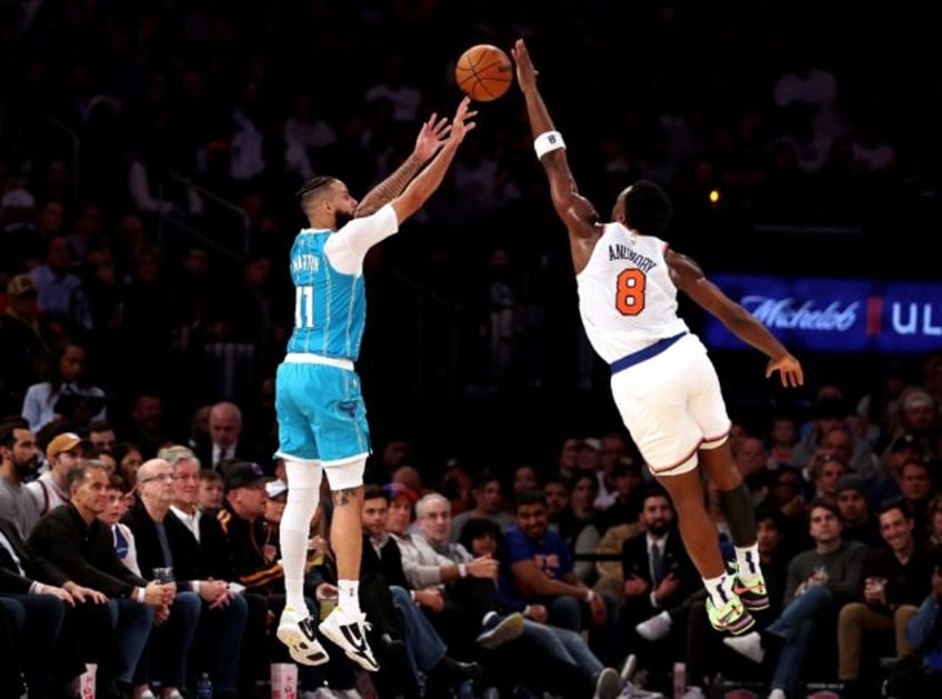 OG Anunoby of the New York Knicks blocks the shot of Cody Martin in the Knicks' NBA victor