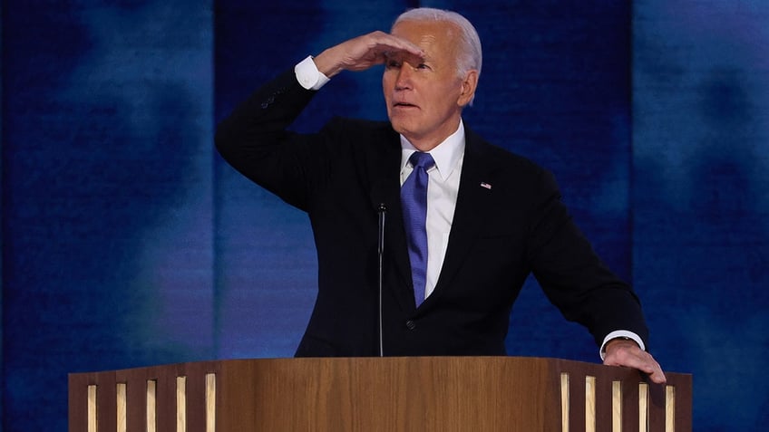 Joe Biden looks on from the stage during Day 1 of the Democratic National Convention