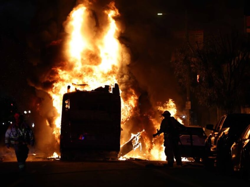 LOS ANGELES, CALIFORNIA - OCTOBER 31: A Metro bus bus burns following Dodger fan celebrati