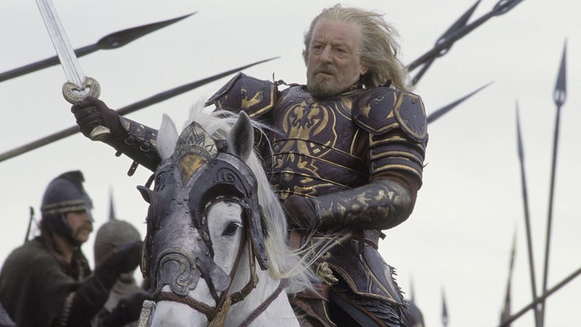 Bernard Hill as Théoden, King of Rohan in The Lord of the Rings riding on a horse