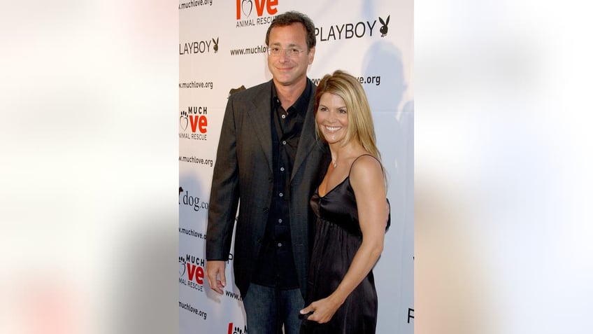 Bob Saget and Lori Loughlin posing together on the red carpet