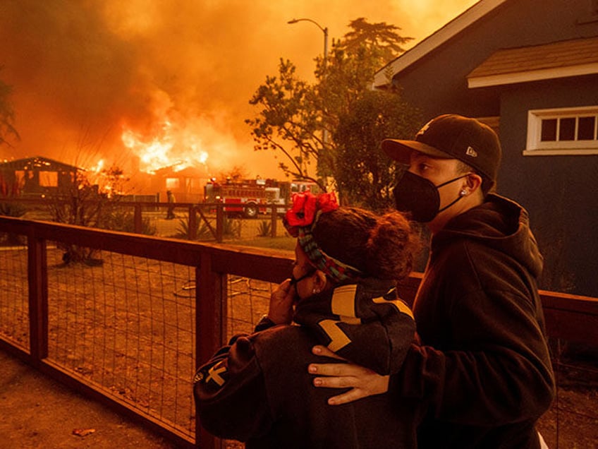 L.A. - People watch as the Eaton Fire destroys a neigborhood Wednesday, Jan. 8, 2025 in Al