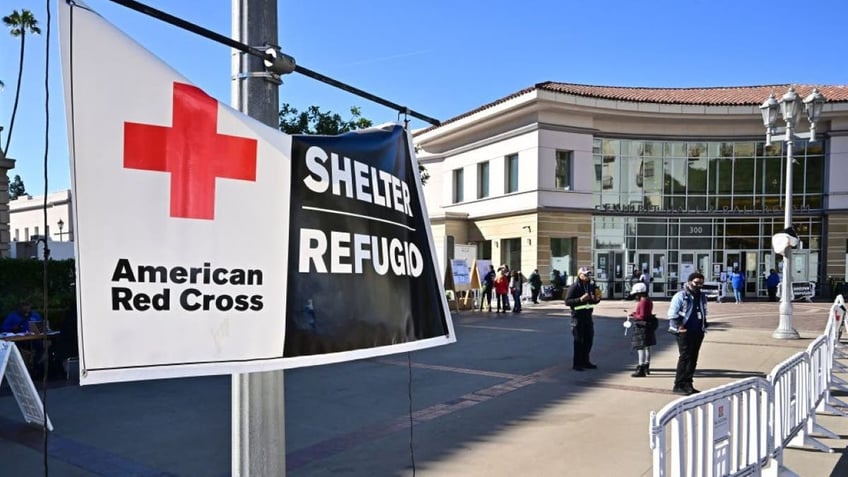 People are seen outside a wildfire shelter at the Pasadena Convention Center on January 21, 2025, where FEMA disaster assistance is available. FEMA has received more than 91,000 applications for assistance from both Los Angeles City and County, and has delivered more than $32 million to wildfire survivors so far. The deadline to register for FEMA and SBA asisstance is March 10, 2025. (Photo by Frederic J. BROWN / AFP) (Photo by FREDERIC J. BROWN/AFP via Getty Images)