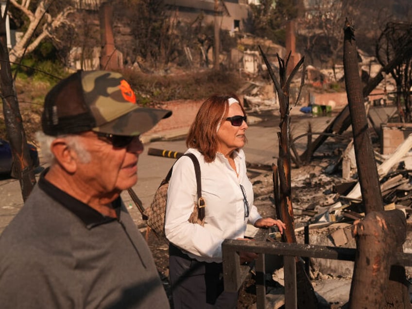 Ali Habibi and his wife Shabnam visit their fire-ravaged home in the aftermath of the Pali