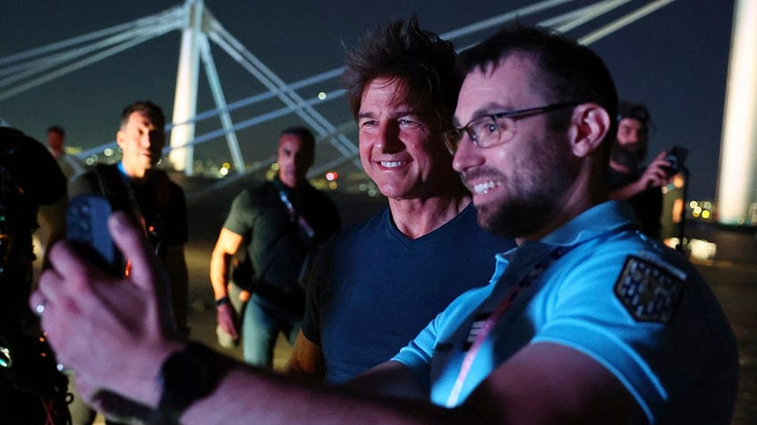 Actor Tom Cruise poses for a photo on the roof of the Stade de France during the closing ceremony of the 2024 Summer Olympics, Aug. 11, 2024, in Saint-Denis, France.