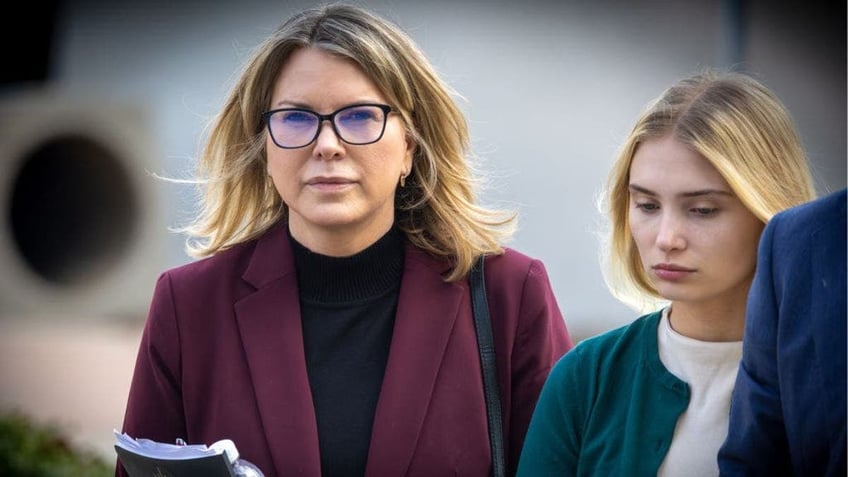 Rebecca Grossman wearing a burgundy blazer as she enters court with her daughter