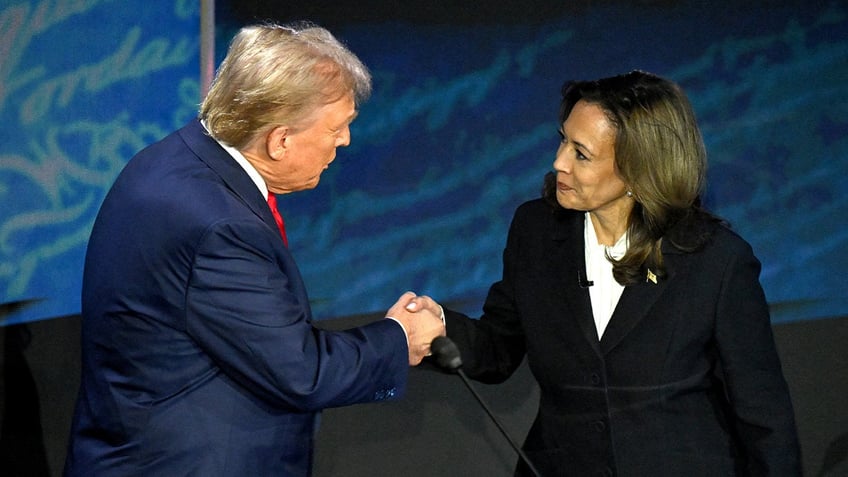 US Vice President and Democratic presidential candidate Kamala Harris (R) shakes hands with former US President and Republican presidential candidate Donald Trump during a presidential debate at the National Constitution Center in Philadelphia, Pennsylvania, on September 10, 2024.