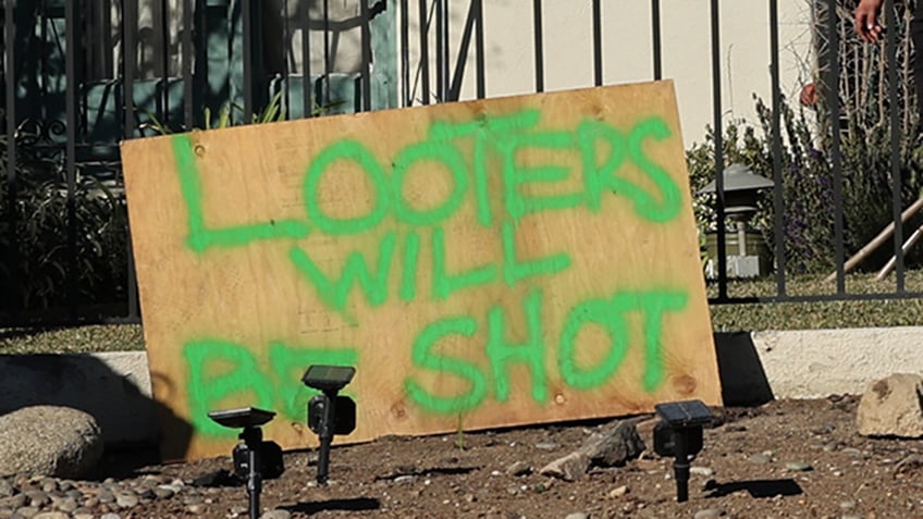 A sign in front of a home in the California fires says looters will be shot