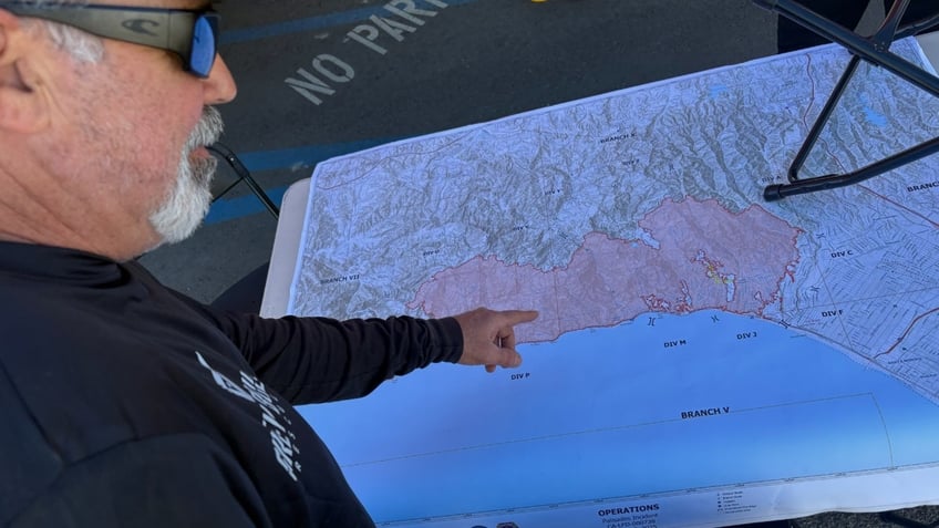 Grey Bull Rescue Chairman Bryan Stern points to a map showing wildfires in California