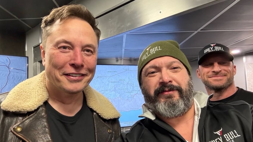 Elon Musk poses with Grey Bull Rescue volunteers