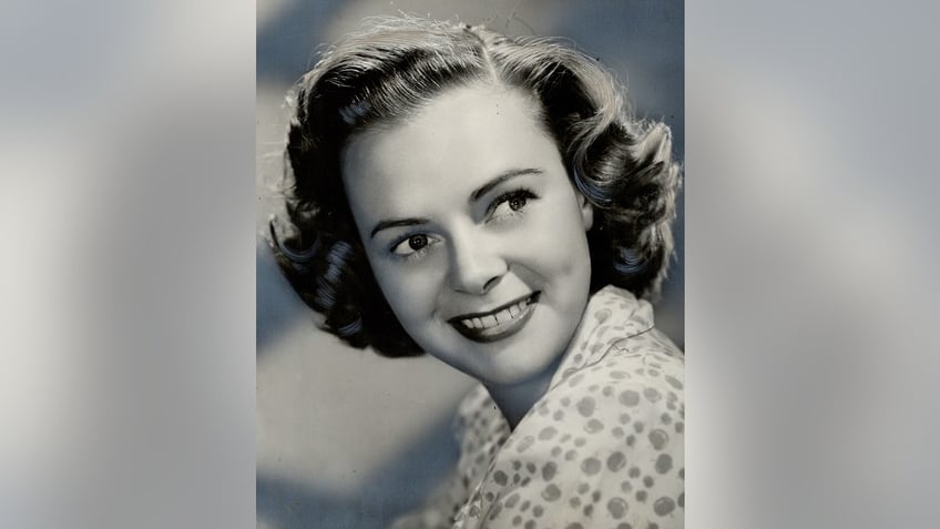 A young June Lockhart posing for a black and white photo