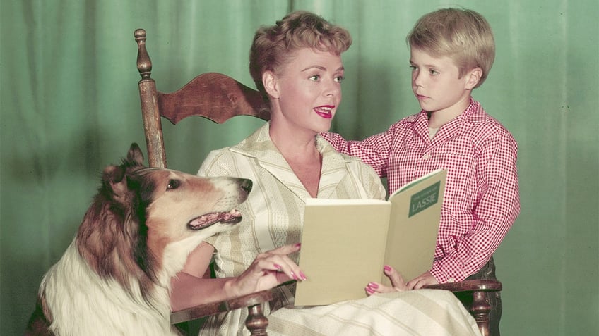 June Lockhart on a chair reading to Timmy and Lassie