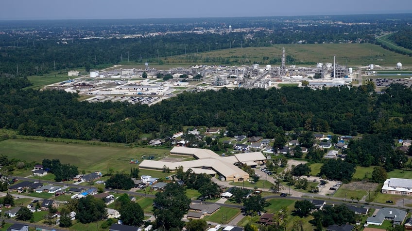 The Fifth Ward Elementary School and residential neighborhoods sit near the Denka Performance Elastomer Plant, back, in Reserve, Louisiana.