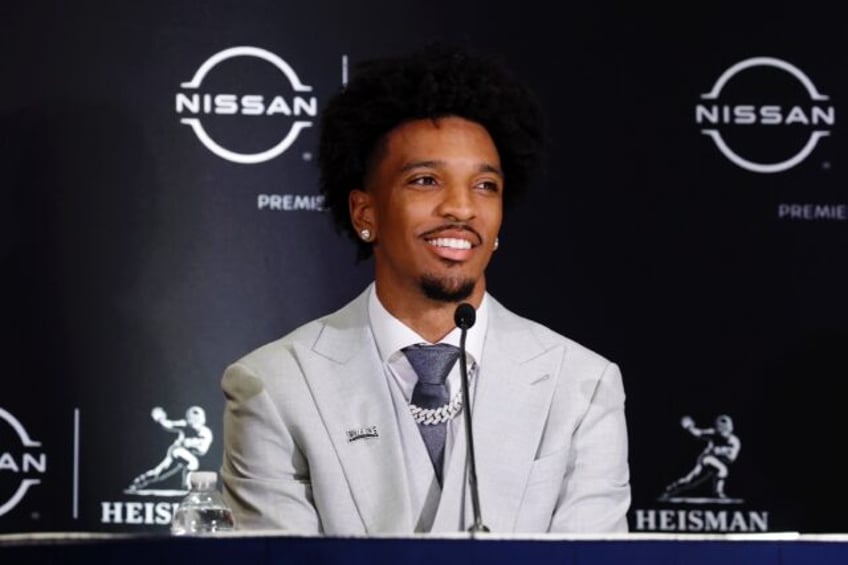 Louisiana State University quarterback Jayden Daniels talks to reporters before receiving the 2023 Heisman Trophy as the most outstanding collegiate football player of the year