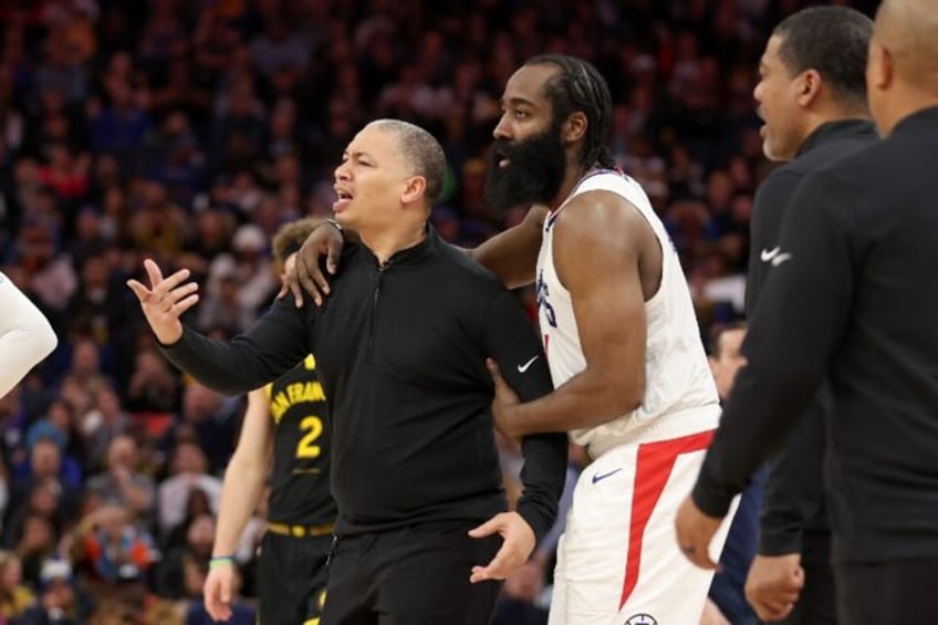 James Harden restrains Clippers coach Tyronn Lue during Wednesday's stormy win over Golden