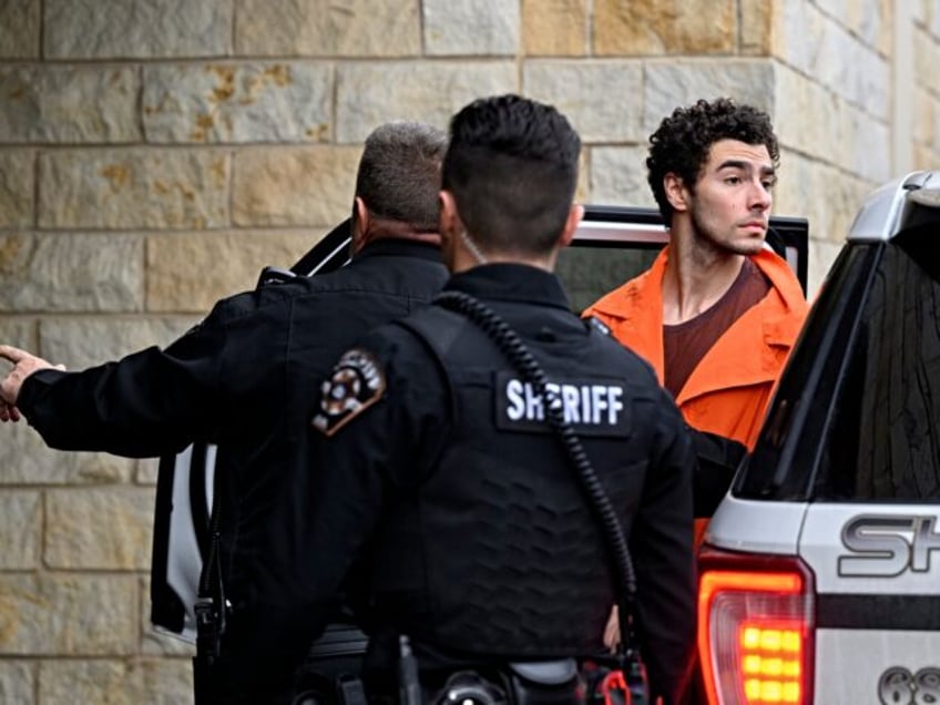 HOLLIDAYSBURG, PENNSYLVANIA - DECEMBER 10: Suspected shooter Luigi Mangione is led into th