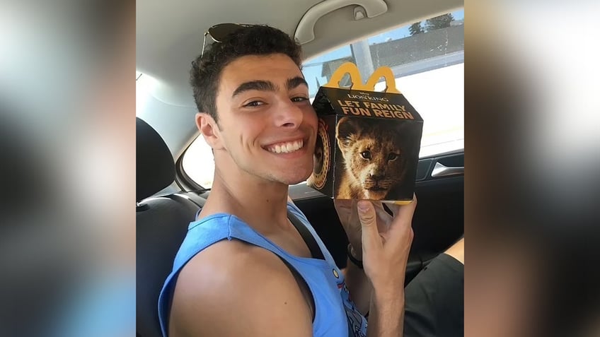 Luigi Mangione poses with a McDonald's fast food package