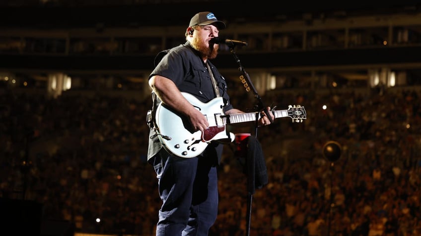 luke combs performing at benefit concert