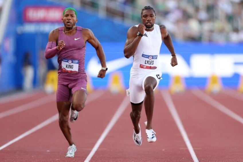 Reigning world champion Noah Lyles, right, won his preliminary heat over Kyree King, left,