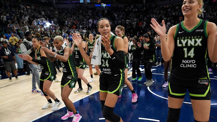 Napheesa Collier and the team celebrates