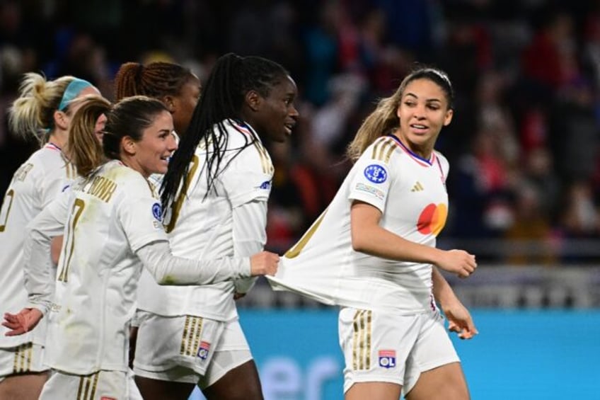 Delphine Cascarino (R) celebrates with team-mates after scoring Lyon's second goal against