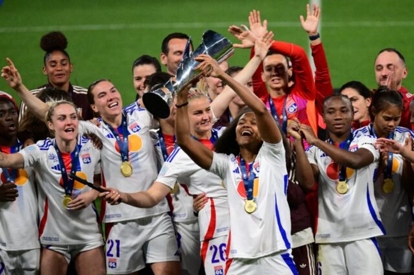 Lyon defender Wendie Renard holds aloft the French first division trophy