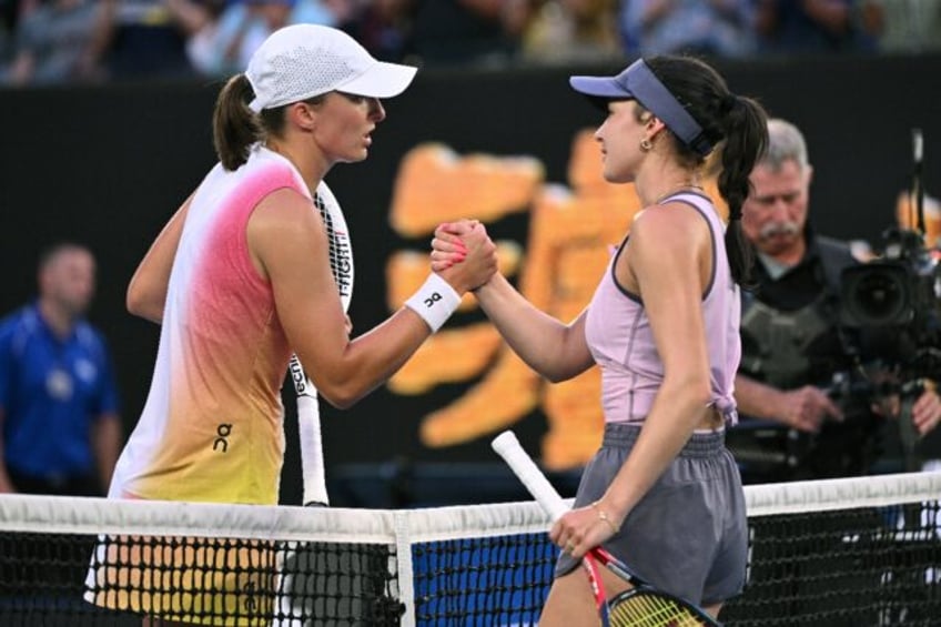 Poland's Iga Swiatek shakes hands with Germany's Eva Lys (R)