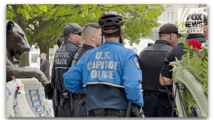 Capitol police with jackets and helmets standing outdoors