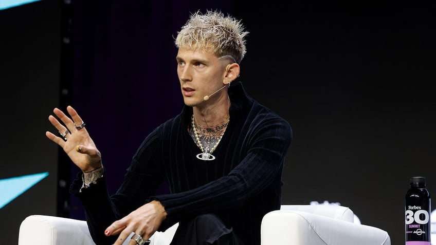 machine gun kelly fan storms stage during panel discussion with musician that was scary