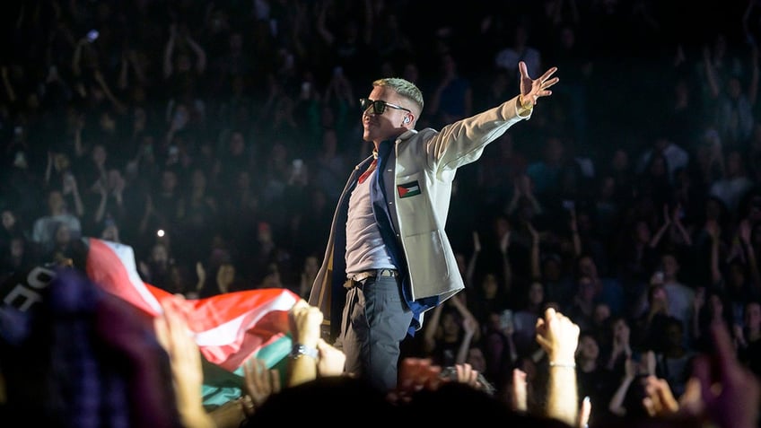 Macklemore with Palestinian flag on jacket on Paris stage