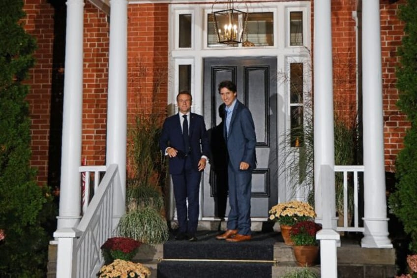 Canada's Prime Minister Justin Trudeau (R) welcomes French President Emmanuel Macron to hi