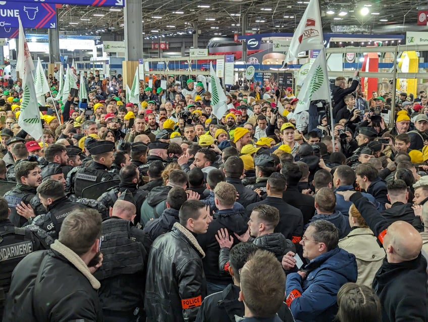 PARIS, FRANCE - FEBRUARY 24: French riot police intervene farmers gathering around the Hall 1 of the Salon de l'Agriculture in Paris this morning, on the sidelines of Emmanuel Macron's visit during 60th International Agriculture Fair (Salon de l'Agriculture) at the Porte Versailles exhibition center in Paris, France on February 24, 2024. Tensions ran high between farmers and French riot police. The Salon de l'Agriculture opened to the public late and Hall 1 is still closed to the public. (Photo by Luc Auffret/Anadolu via Getty Images)