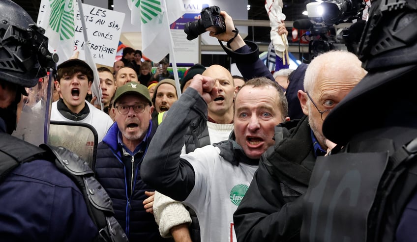 PARIS, FRANCE - FEBRUARY 24: French farmers protest inside the Porte de Versailles exhibition centre on the day of French President Emmanuel Macron's visit to the International Agriculture Fair (Salon International de l'Agriculture) during its inauguration on February 24, 2024 in Paris, France. Several dozen demonstrators entered the Salon without authorization on Saturday morning to try to meet the Head of State after several weeks of mobilizations by part of the agricultural world. (Photo by Chesnot/Getty Images)