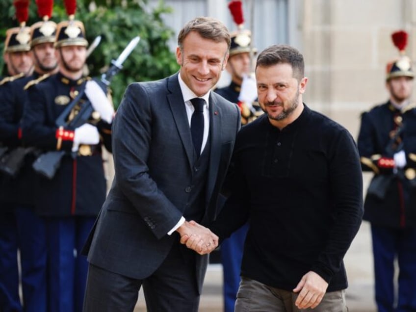 TOPSHOT - France's President Emmanuel Macron (L) shakes hands with his Ukrainian counterpa