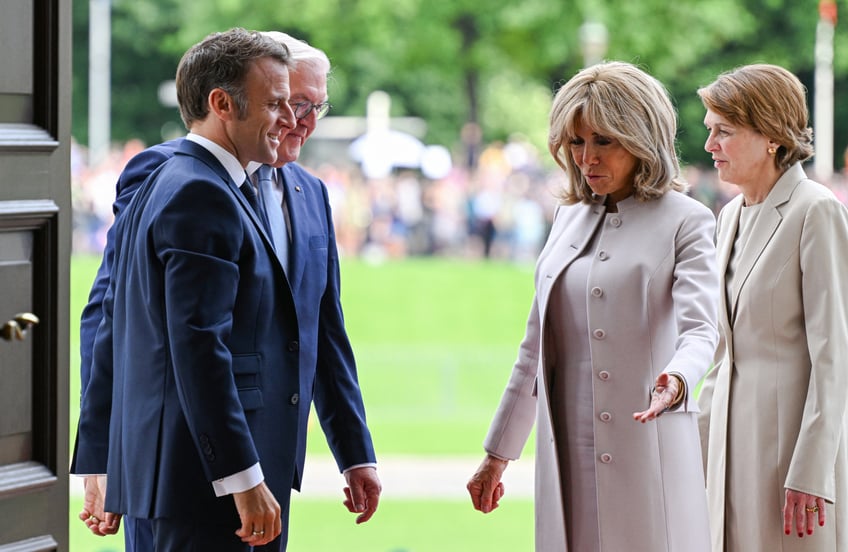 French President Emmanuel Macron (L), his wife Brigitte Macron (2nd R), German President Frank-Walter Steinmeier (2nd L) and his wife Elke Buedenbender (R) react during a welcoming ceremony at Bellevue presidential palace in Berlin, Germany on May 26, 2024. The French president pays a three-day state visit to Germany until May 28. (Photo by RALF HIRSCHBERGER / AFP) (Photo by RALF HIRSCHBERGER/AFP via Getty Images)