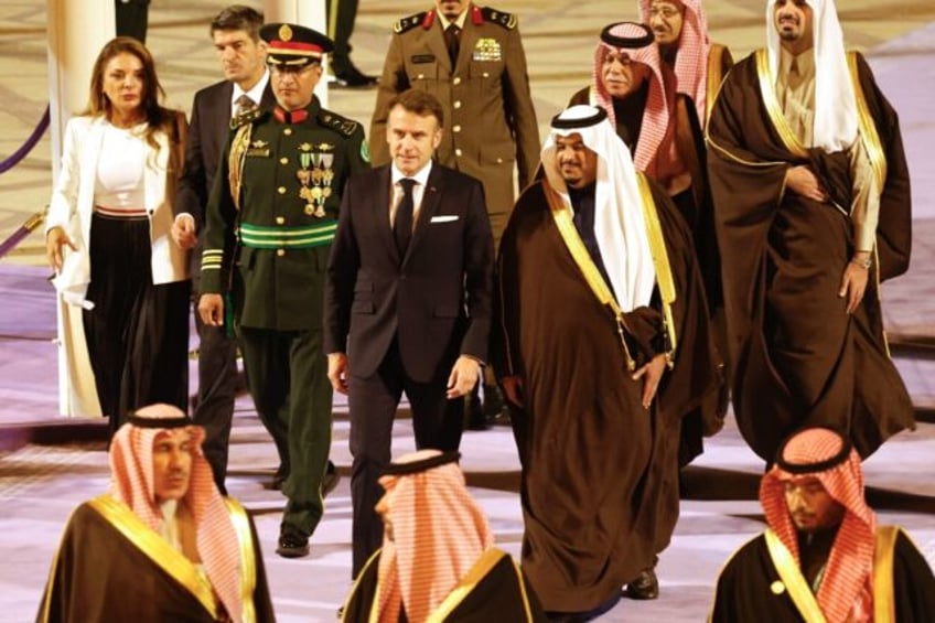 French President Emmanuel Macron (C-L) was received by Crown Prince Mohammed bin Abdulrahm