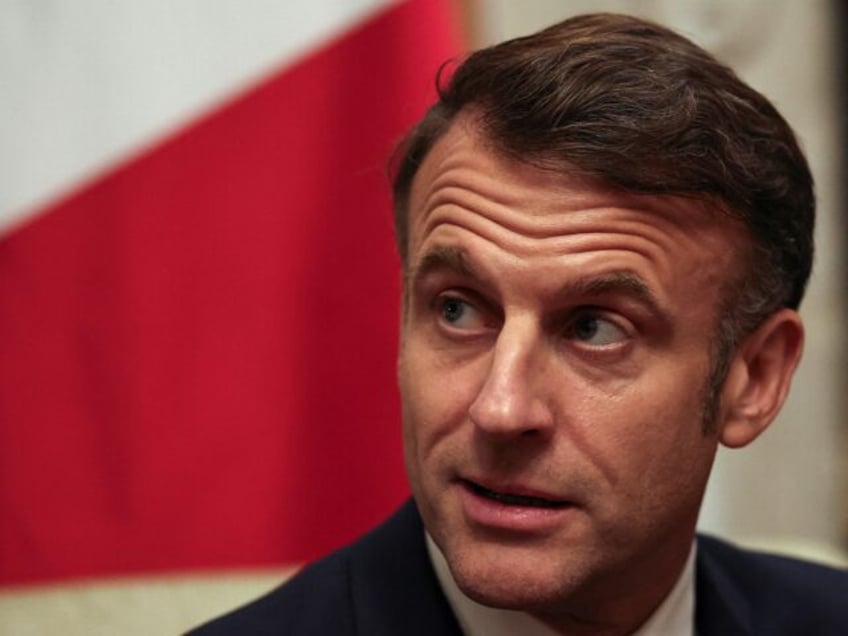 France's President Emmanuel Macron reacts during a bilateral meeting with Britain's Prime